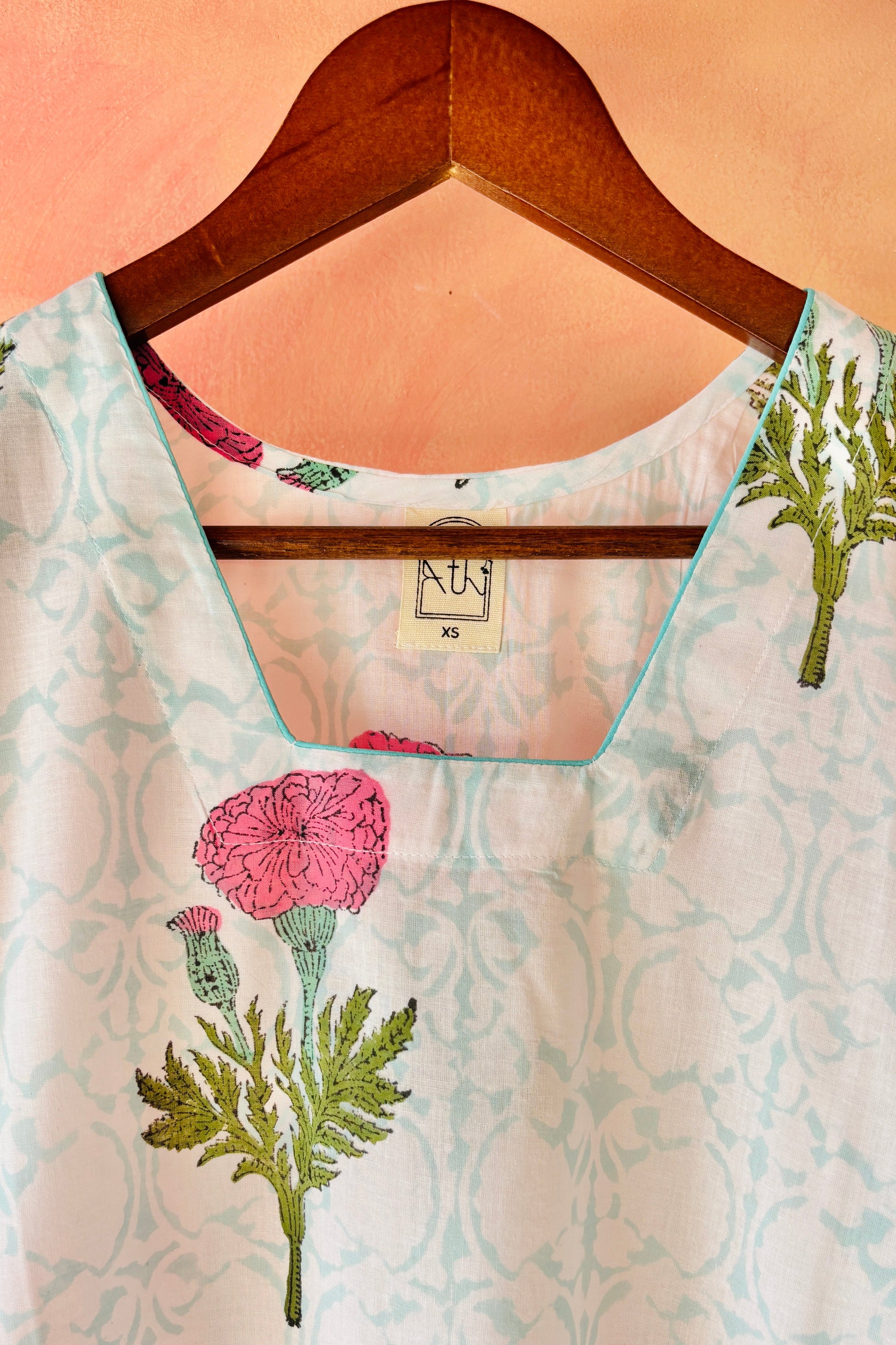 white with Light blue kurta with floral print on a hanger