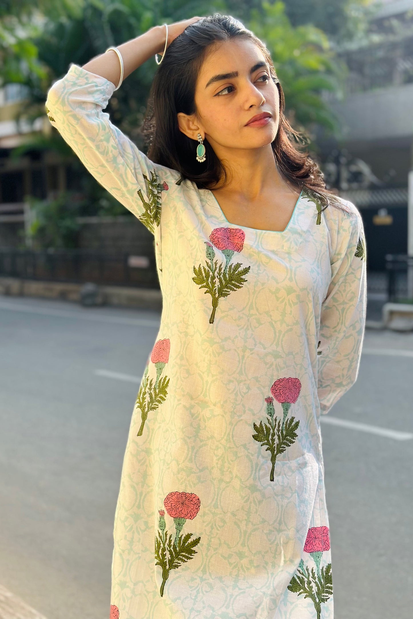Woman wearing a floral printed kurta on a street.